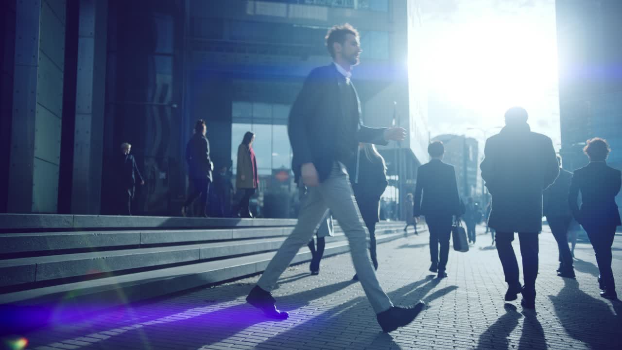 Office Managers and Business People Commute to Work in the Morning or from Office on a Sunny Day on Foot. Pedestrians are Dressed Smartly. Successful People Walking in Downtown. Cloudy Day in Downtown