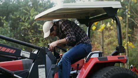 man driving a tractor in a forest