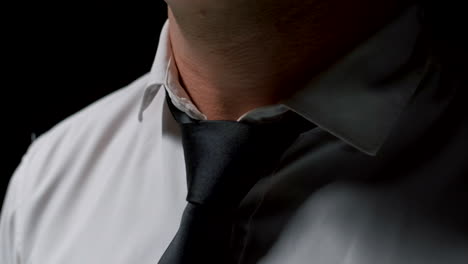 man adjusting his shirt collar