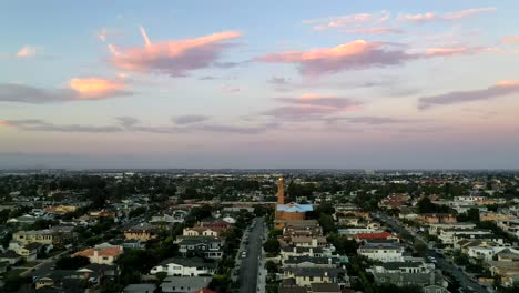 distant view of church tower in manhattan beach, california at sunset