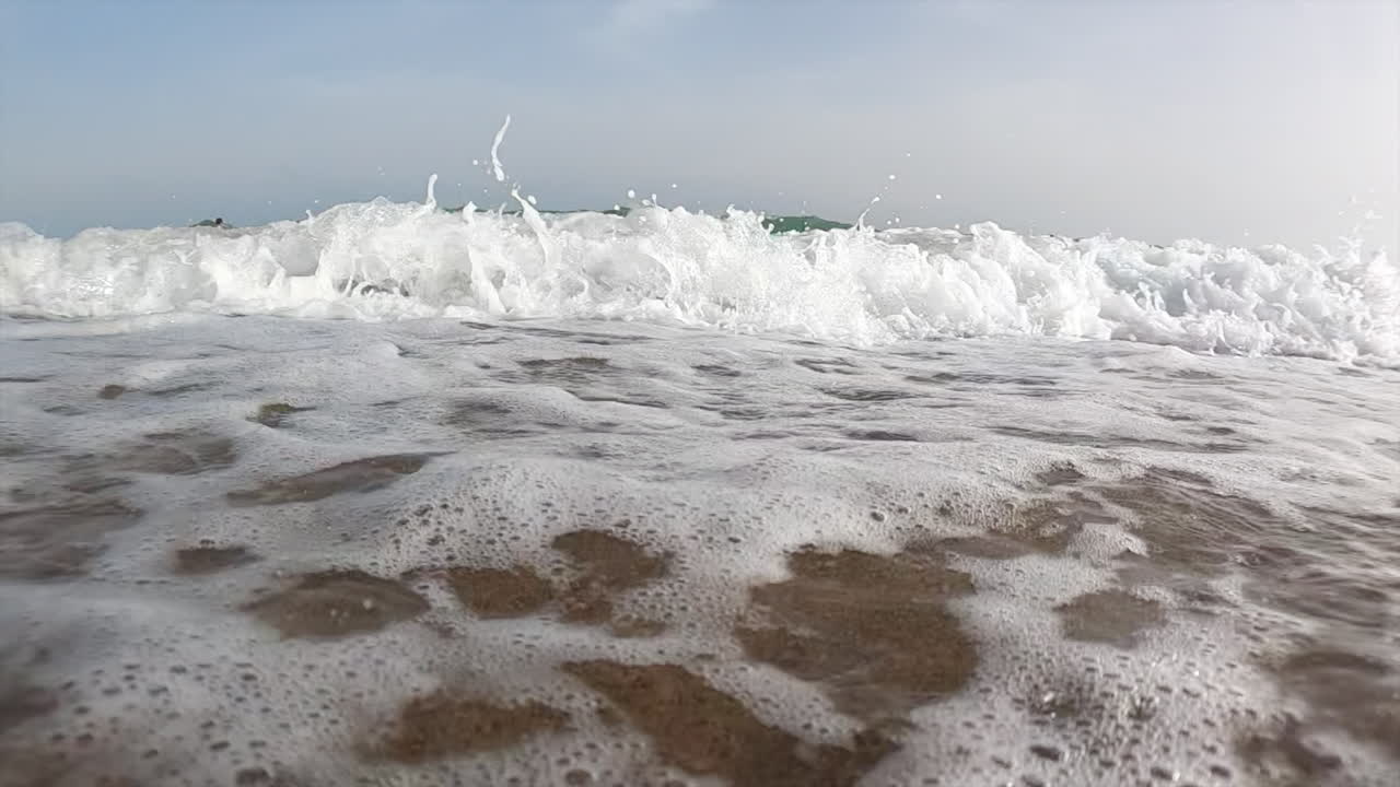 Waves hitting the shore on the beach