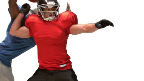 serious american football player tackling for ball