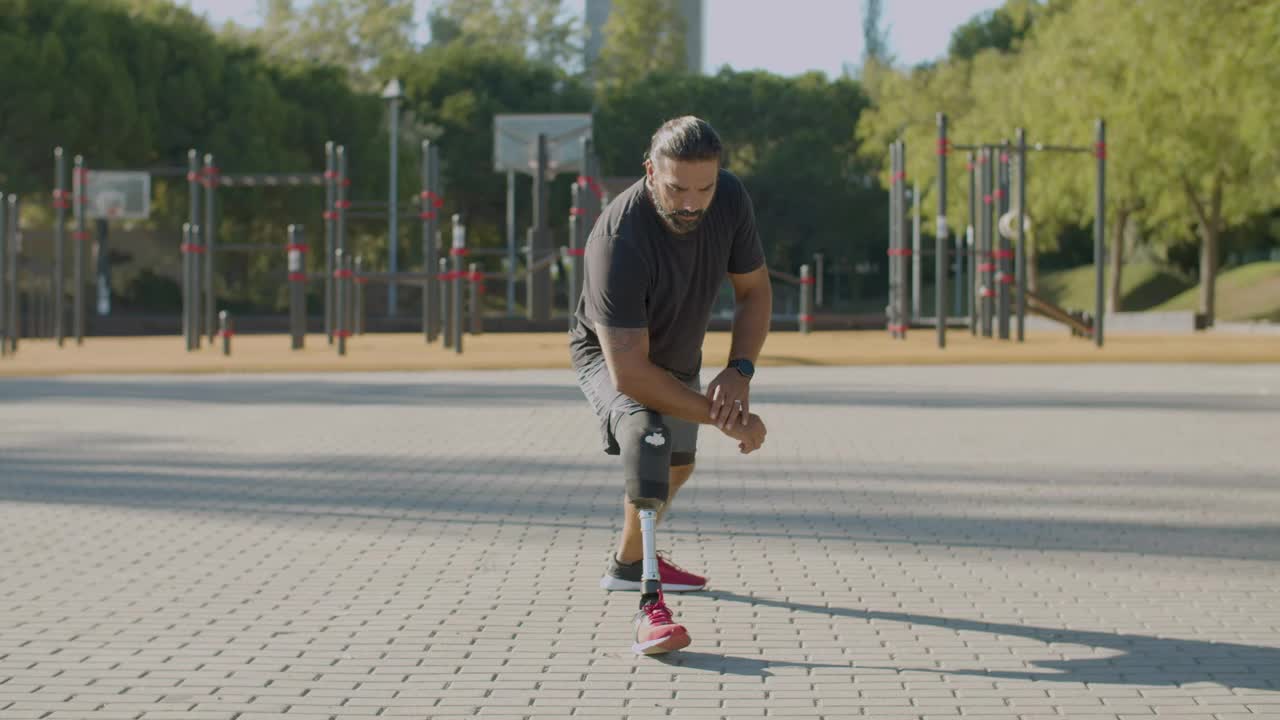 Front view of athlete with disability doing stretching exercises
