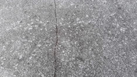 cracked ice icy frozen lake crack top view from above, aerial