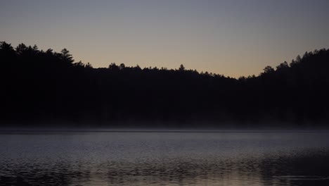 reflections on lake opeongo at sunrise, algonquin provincial park