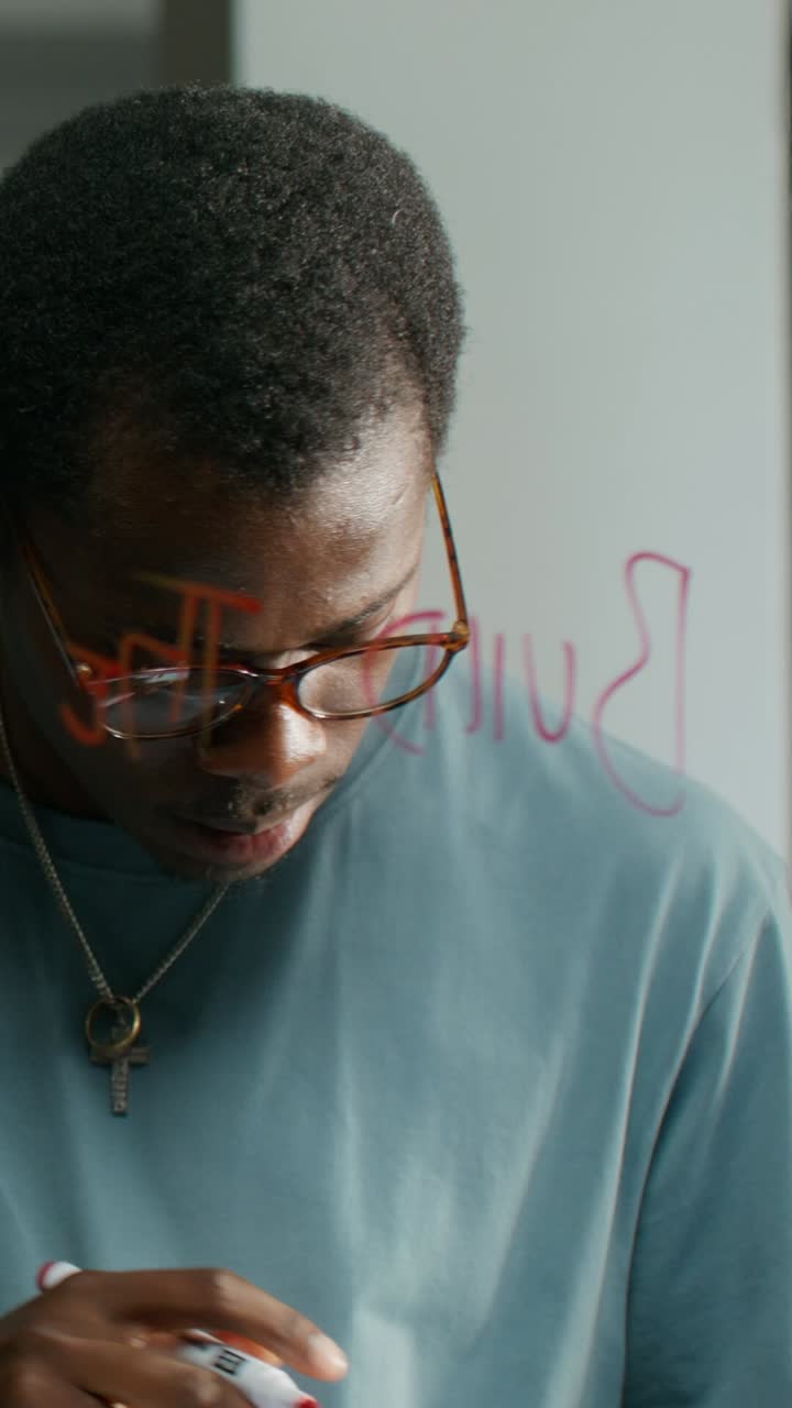 Person Writing on Glass