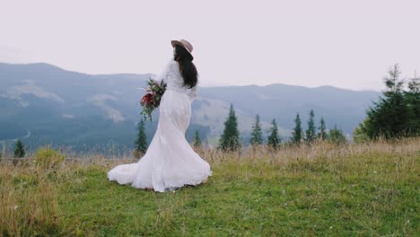beautiful bride in white dress. young bride posing on the mountain hills