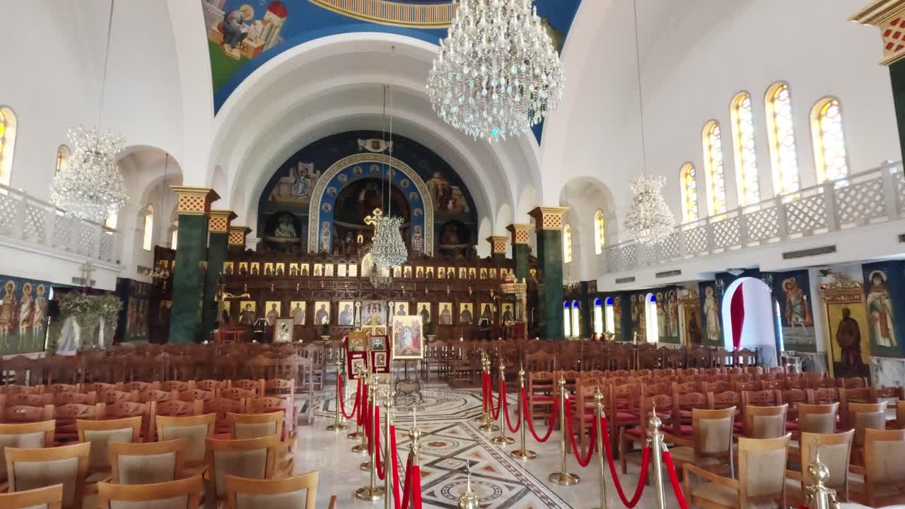 Step into a breathtaking church where golden chandeliers hang from a high ceiling, and vibrant frescoes tell sacred stories. The tranquil setting invites reflection and admiration