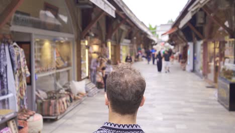 young man walking in the old covered market.