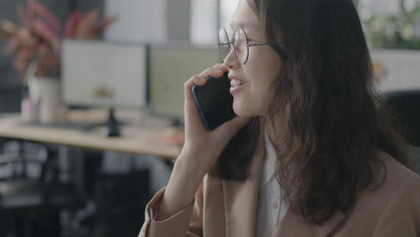 young woman on phone call in office