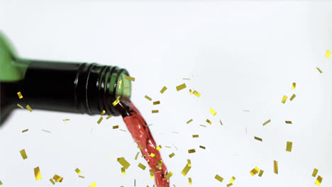 animation of confetti falling over bottle of wine on white background