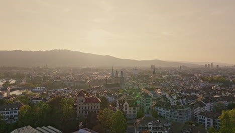 golden summer sunset over zürich, captured by drone with stunning views of the city, lake, river, and iconic churches.