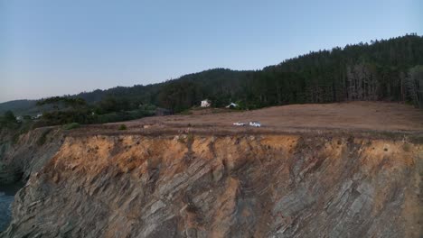 Drone-shot-flying-over-the-California-coastline-at-golden-hour-to-reveal-a-private-wedding-venue