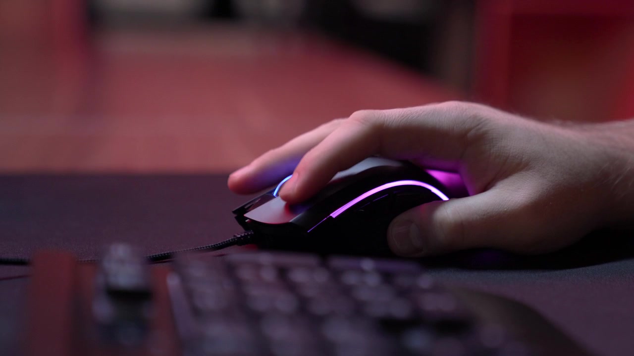 Close-up of Hand Clicking RGB Gaming Mouse in Dark Room