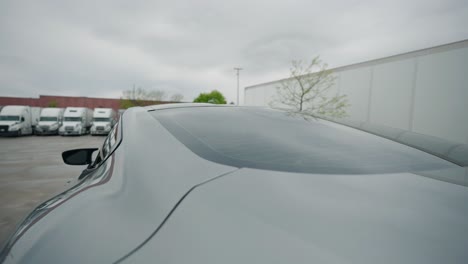 revealing-freshly-cleaned-sport-car-on-a-truck-parking-yard