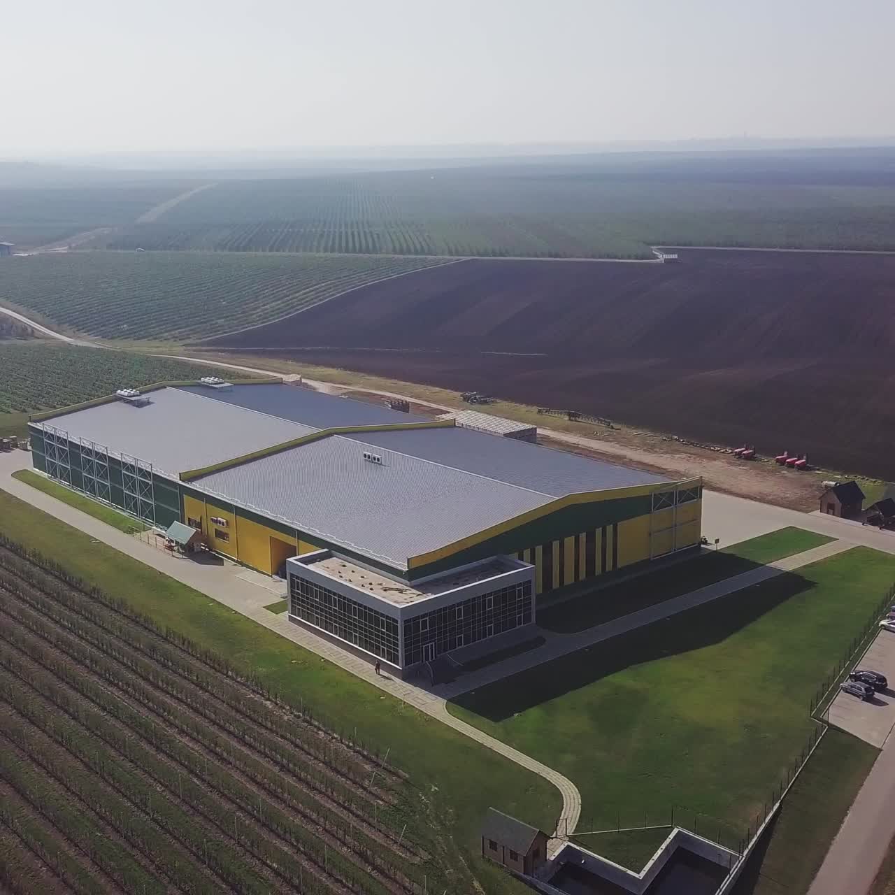 Aerial over fruit orchard farm showing different buildings to warehouse apples and pears also in background showing trees that grow the fresh fruit important food production site healthy food 4k