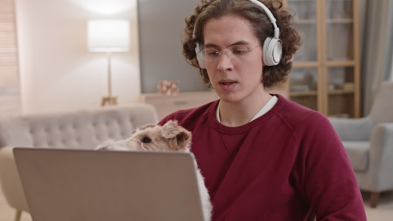 Man Working with Dog in Arms