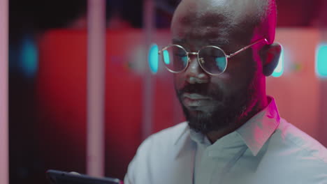 focused man using a tablet in a modern tech environment