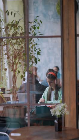 woman working in a cafe with a laptop