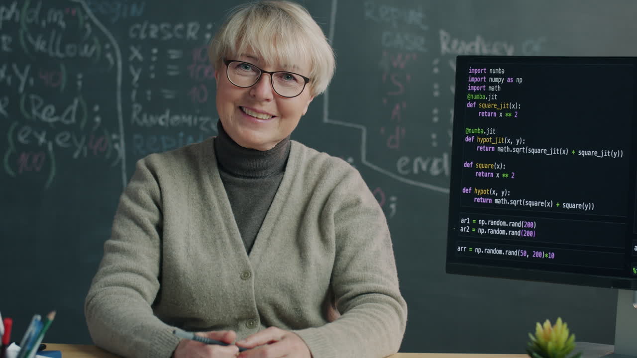Smiling Teacher Explains Code in Classroom