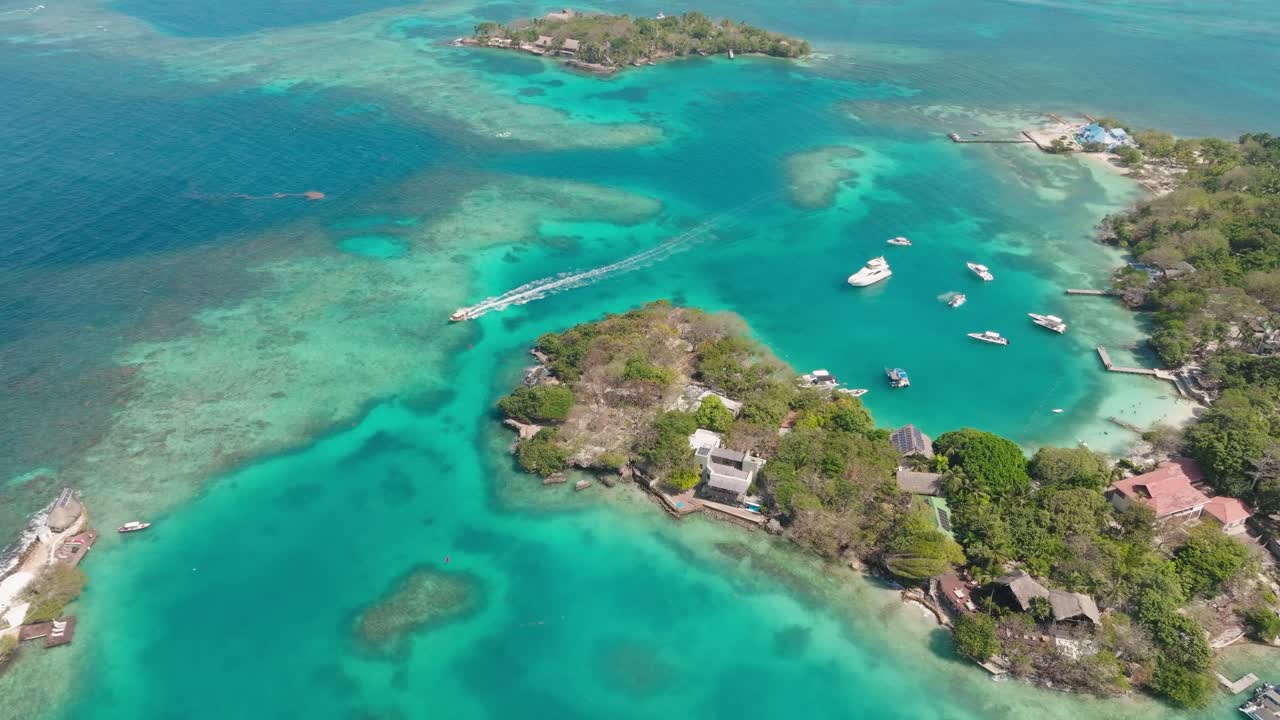 Drone view of Isla Grande in Rosario Islands, Colombia, surrounded by crystal clear Caribbean waters, coral reefs and lush tropical scenery