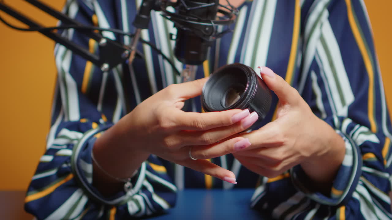 Close up of content creator making a review for new camera lens