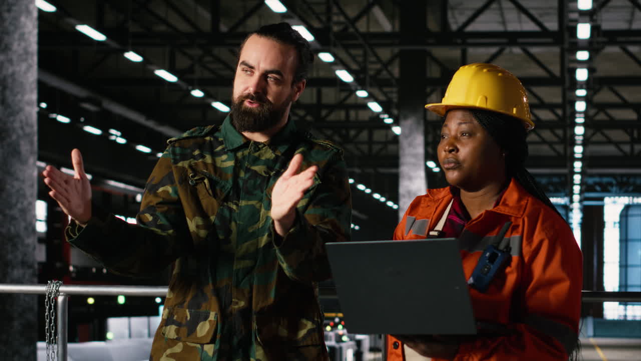 Military officer and engineer discussing armament production