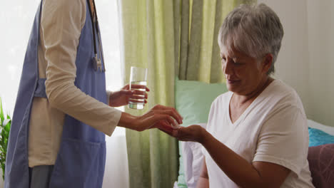 nurse helping a senior woman in a retirement home