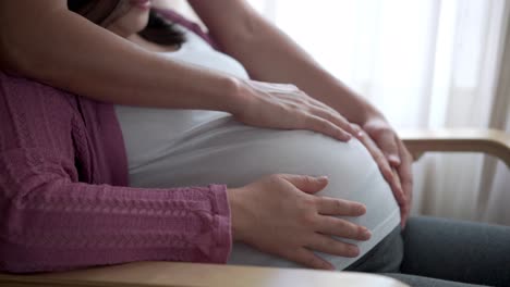 pregnant couple feels love and relax at home.