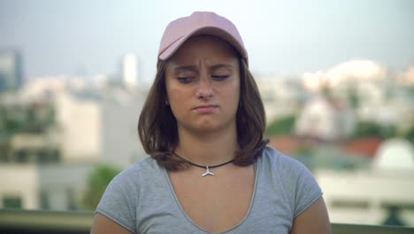 teenage girl confused on a rooftop