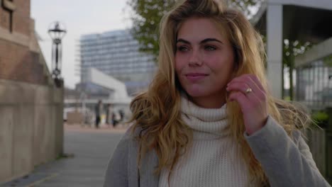 smiling young woman takes a stroll down a city street