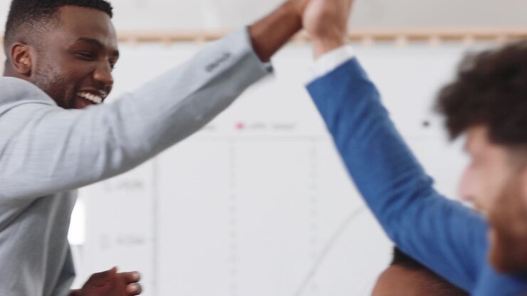 Diverse Business Team Celebrating Success with High Fives in Office