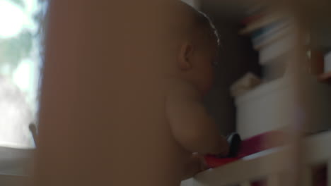 child exploring space outside the crib