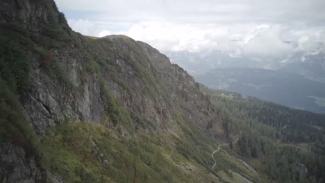 Schärding-Mountainside-drone-shot-along-rocks-in-fall,-Austria