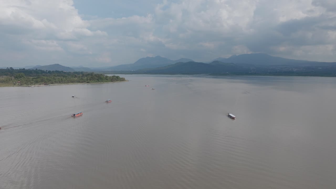 DRONE: DOLLY IN OF PATZCUARO LAKE BOATS HEADING TO THE HARBOR