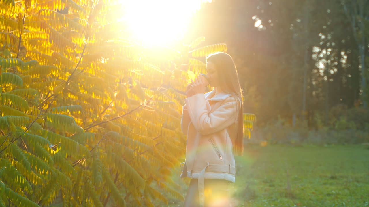 Woman enjoying coffee in autumn park