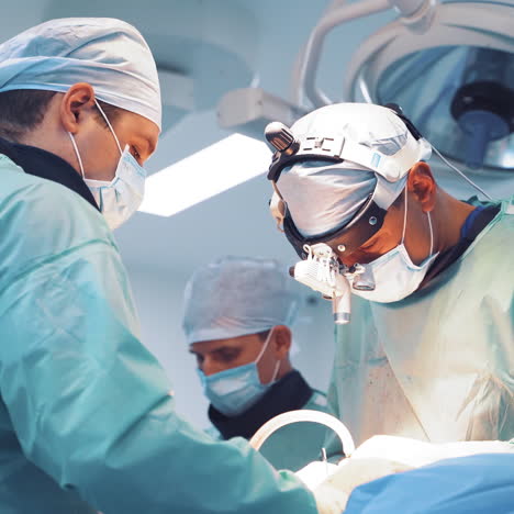 professional doctors in masks and medical uniform are doing operation. close-up faces of surgeons with protective clothing performing an operation in clinic. doctor's concept.
