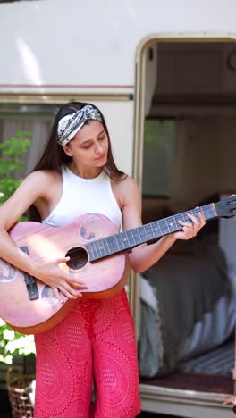 woman playing guitar outdoors