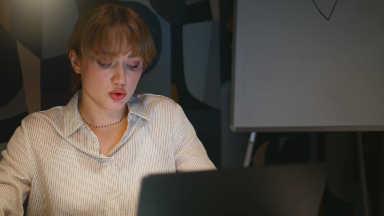 Late businesswoman talking online interview sitting office with laptop closeup