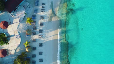 top down pan along grote knip beach at curacao, crystal clear water and white sand