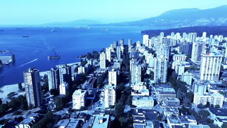 barge beached in vancouvers sunset beach business as usual as speed boats pass by and tourists enjoy the view aerial panoramic flyover westside of downtown bc mountain overview reveal 4k beauty