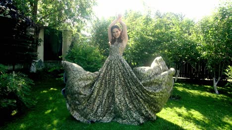 woman in a gold and black embroidered gown in a garden