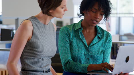 Two-female-architects-discussing-design-plans,-close-up