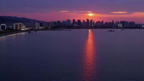 puesta de sol sobre una ciudad costera