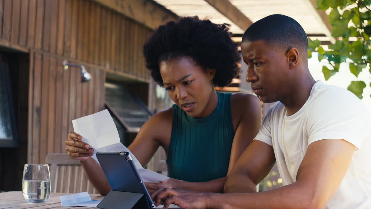 Worried Couple Using Laptop At Home To Check Domestic Finances