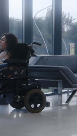 woman in wheelchair in modern waiting area