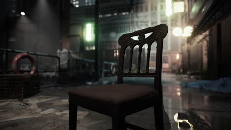 a lone chair sits in a dark alleyway in a city at night.