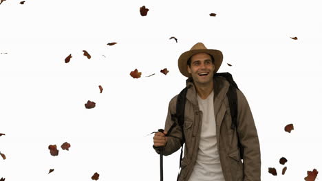 Cheerful-man-standing-under-leaves-falling-on-white-screen