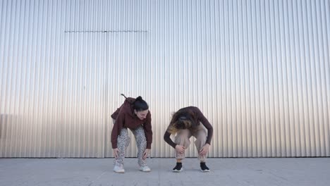 energetic female dancers performing choreography in urban setting