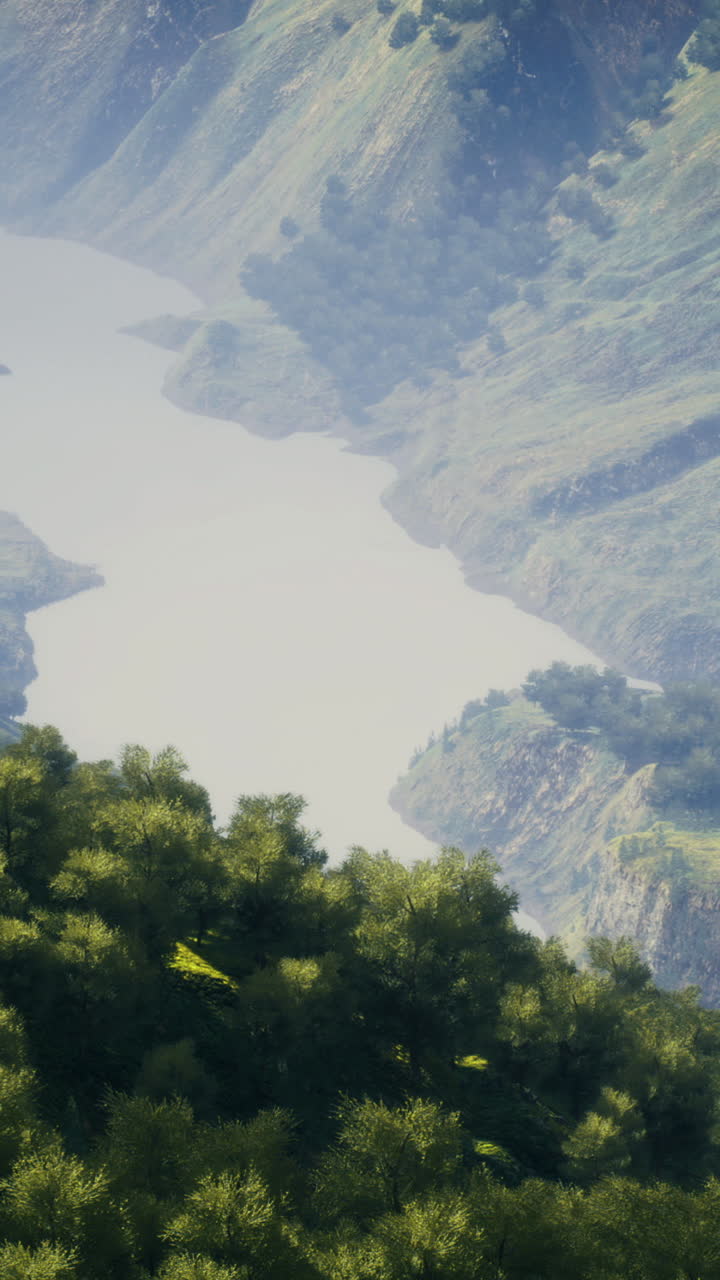 Breathtaking river winds through lush mountains under sunny sky